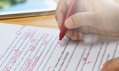 Person making proofreading marks on a document. 