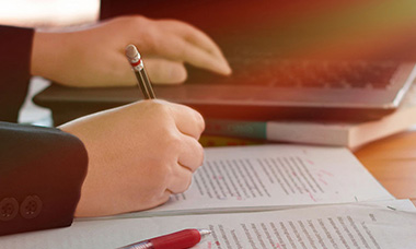A person editing papers.