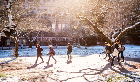 Students walk across a snowy UW campus.