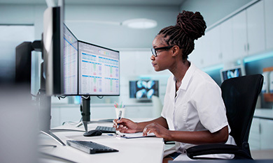 person looking at spreadsheets at desk