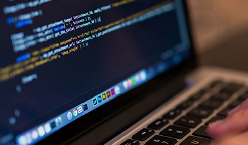 laptop with code displayed on screen