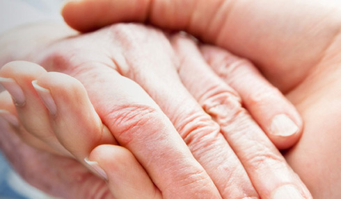 hands holding one younger one older