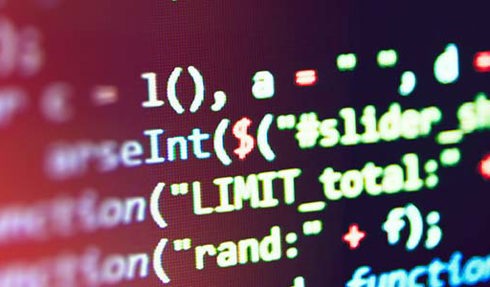 close up of code in yellow text against a dark red-black background