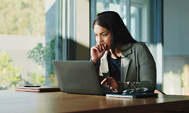 Woman staring into a laptop