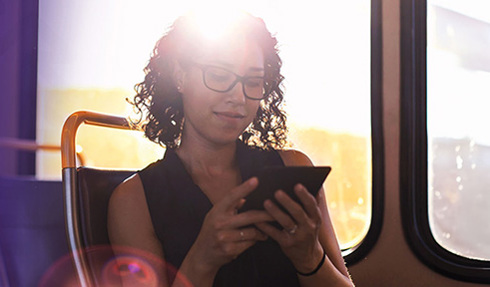 person looking at mobile device on bus