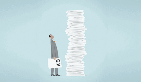 Person staring at a stack of paper.