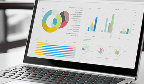 laptop with charts and graphs on screen