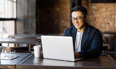 man if cafe working on laptop